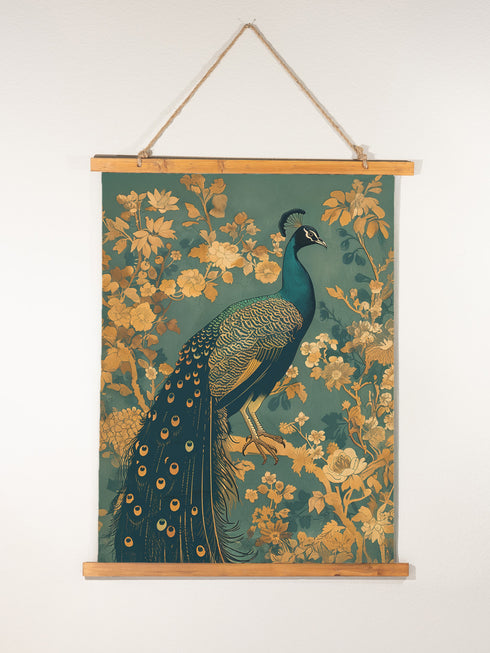 A wall tapestry featuring a detailed teal peacock with golden accents and intricate plumage, surrounded by ornate golden flowers and foliage on an emerald green background, mounted between wooden dowels with twine.